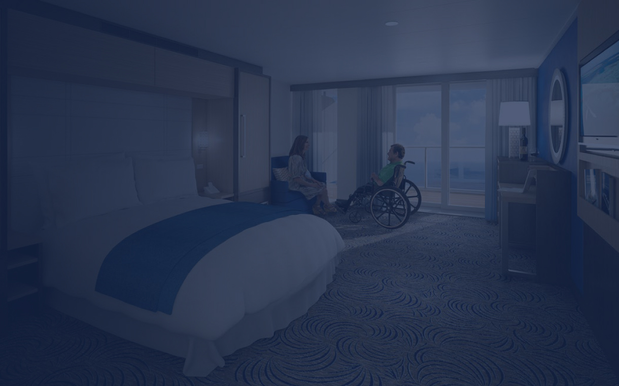 A gentleman on a wheelchair with his wife in his stateroom onboard a ship